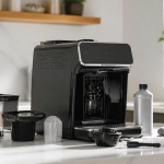 Philips coffee maker on a kitchen counter with cleaning tools nearby